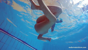 Young European Woman With Natural Beauty Sunbathes Nude By The Pool