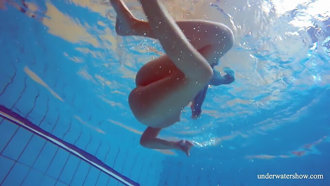 Young European Woman With Natural Beauty Sunbathes Nude By The Pool